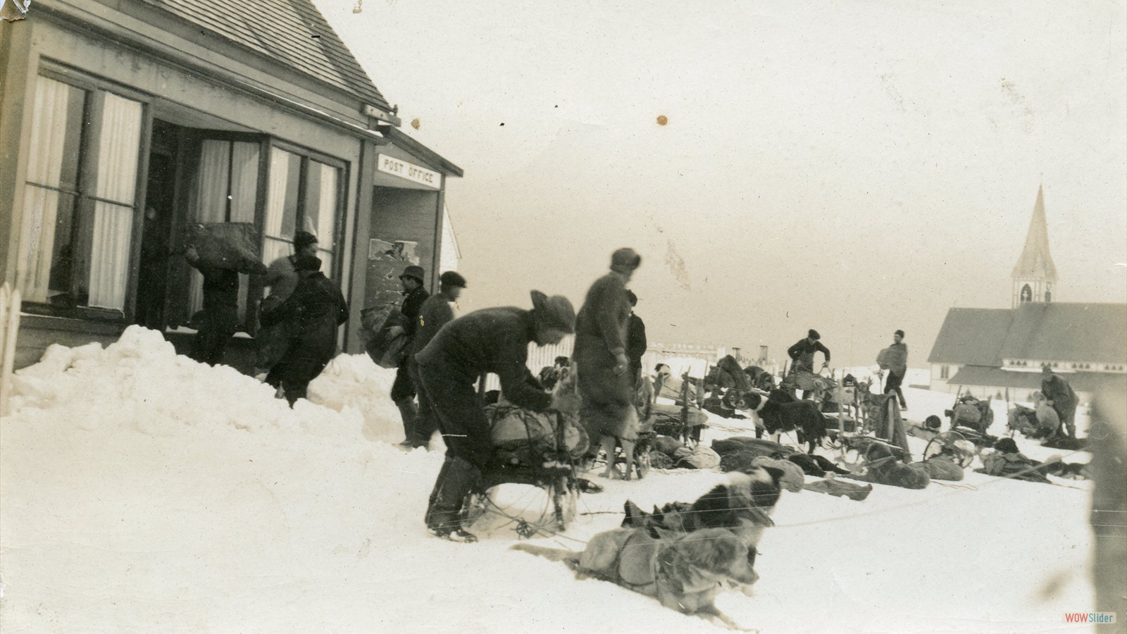 Mail being dropped off at the Post Office by dog sled team which was located at the Hiscock House 